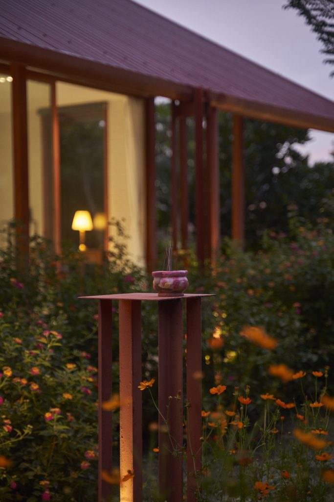 Garden House by aha.studio.arc, Go Quao, An Giang, flower garden in front of the glazed facade