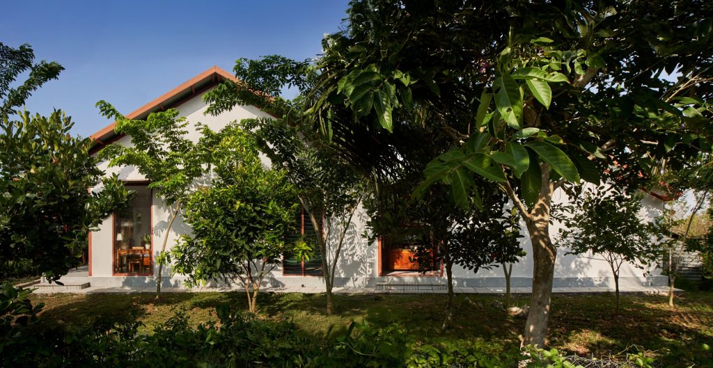 Garden House by aha.studio.arc, Go Quao, An Giang, side view among the fruit trees