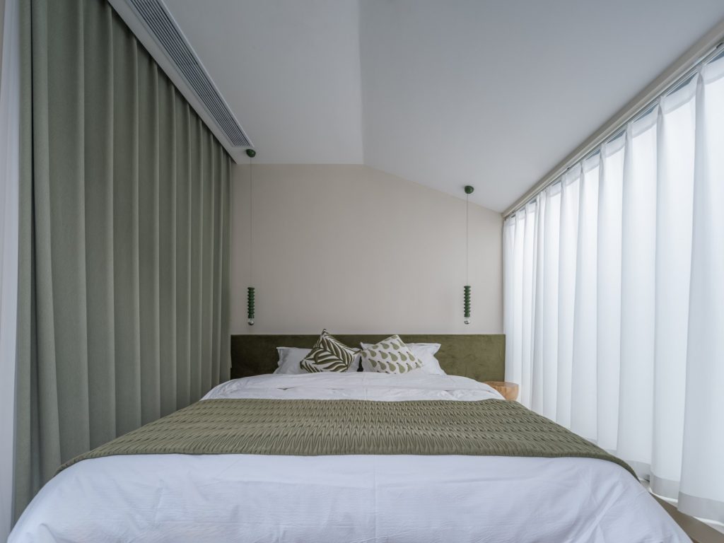 Guest room with a pale sloping ceiling