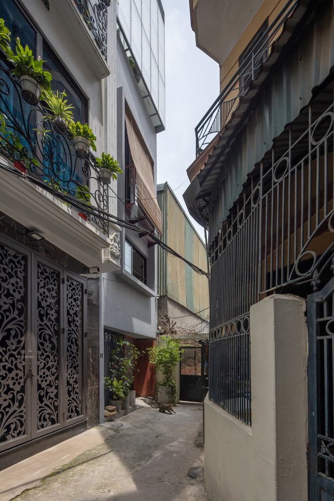 Loli House rising above a narrow Hanoi alley