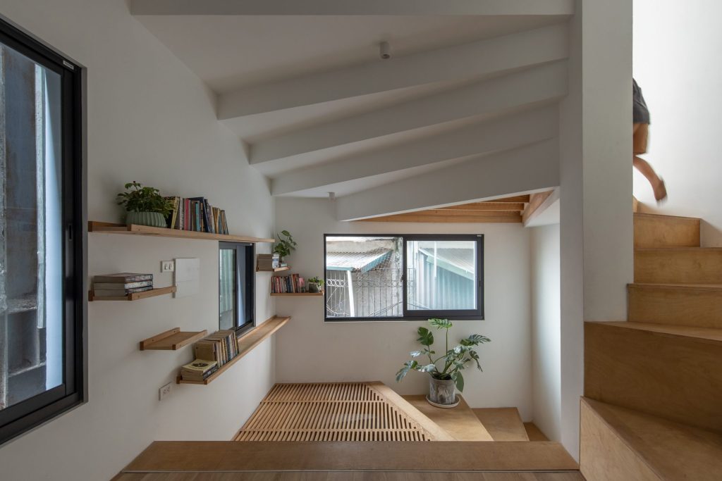 Broad timber steps beside a television and window