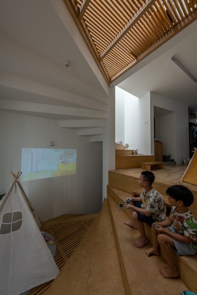 Children watching a projected image from timber steps