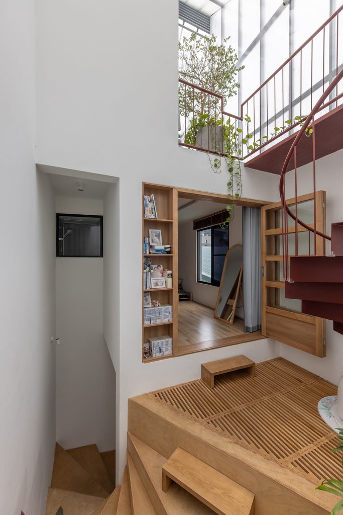 Timber landing beside a red spiral stair