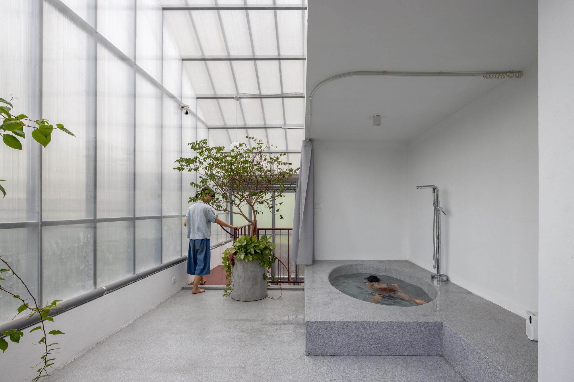 Sheltered bathing area beneath translucent cladding