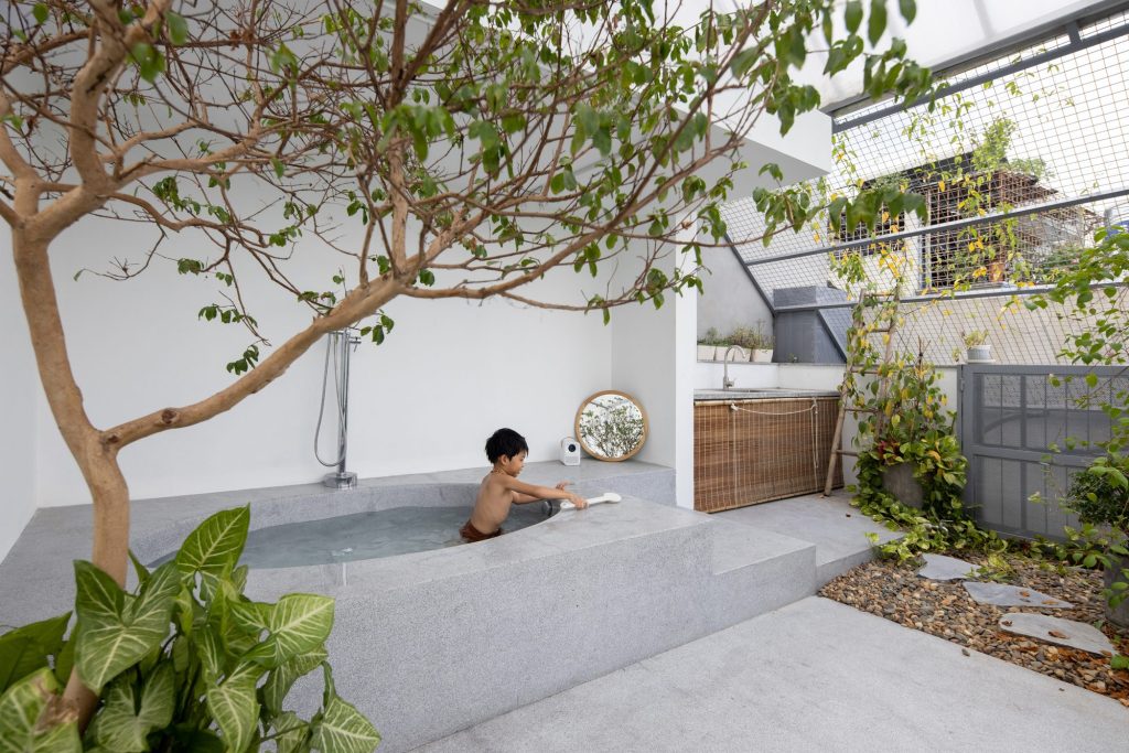 Bath beside a tree within the translucent enclosure