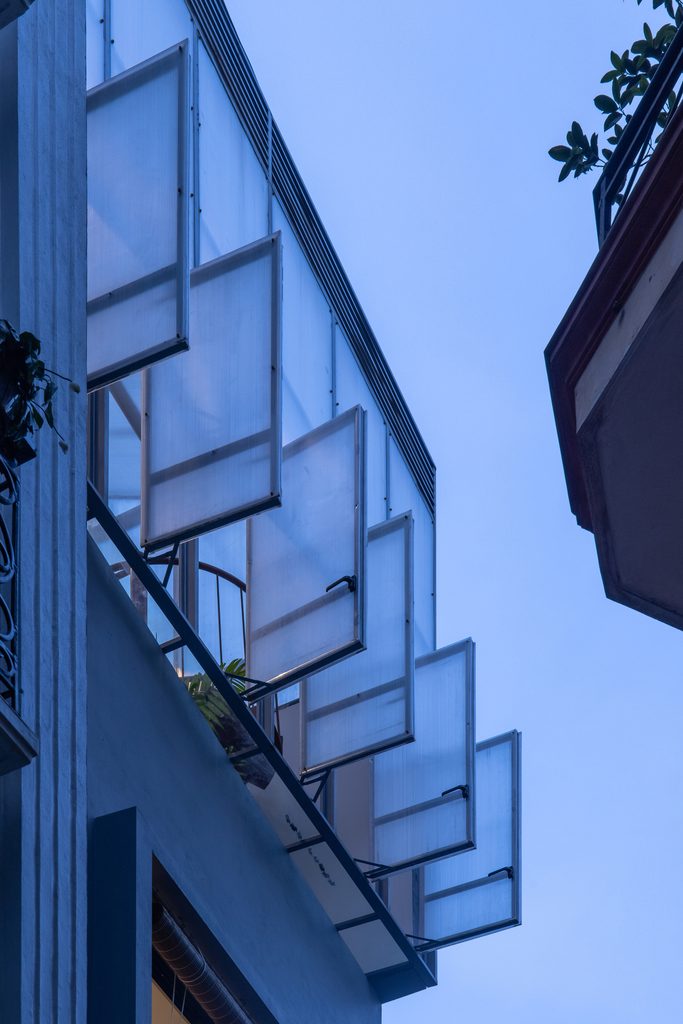 Open translucent panels on the upper facade