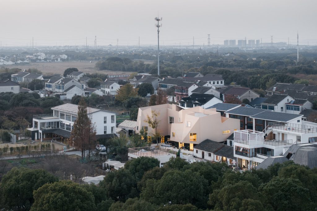The guesthouse among village houses, seen from the air