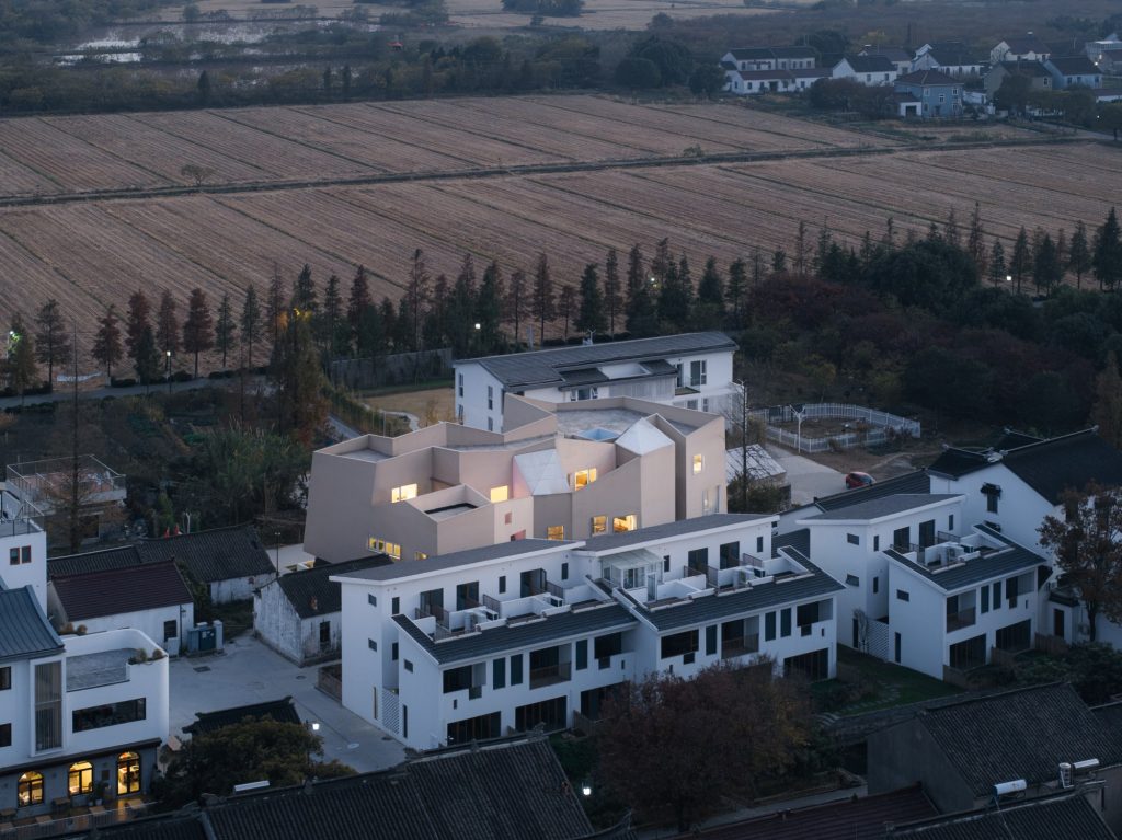 The white mass above the village roofs and fields
