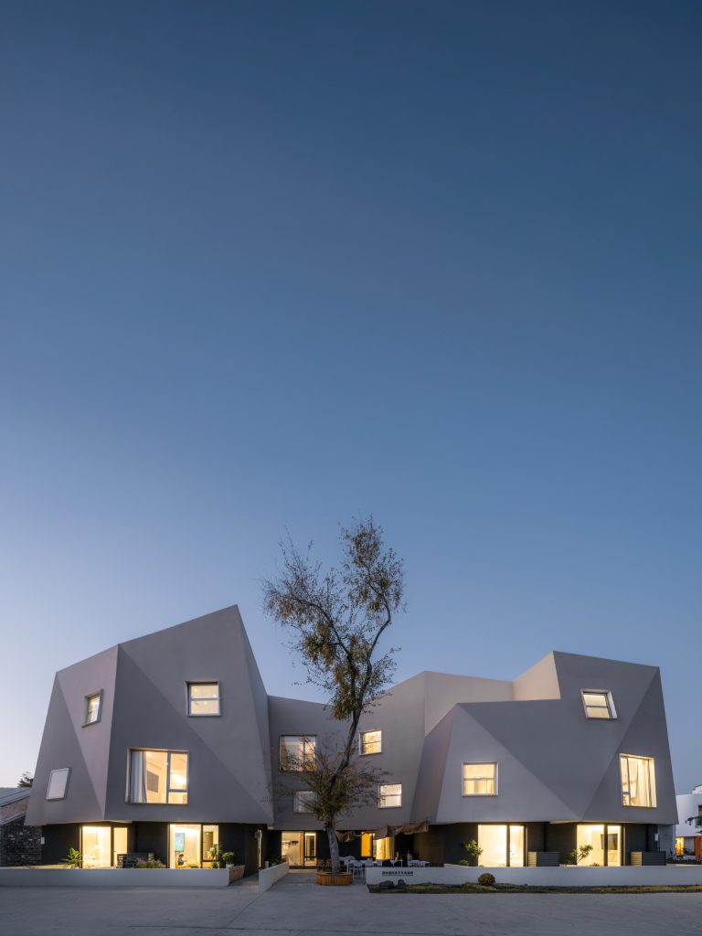 The building lit at dusk
