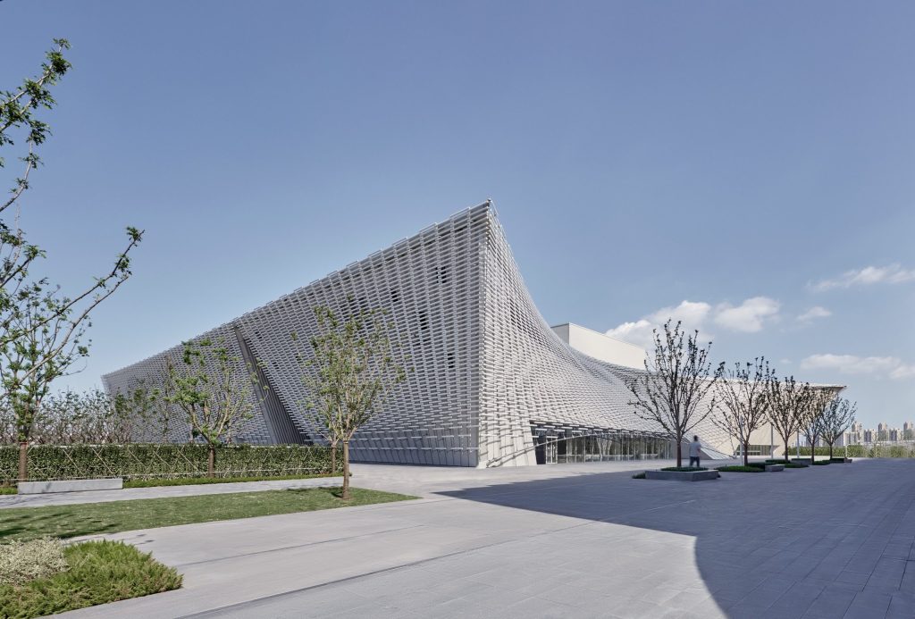 Sloping roofline rising from the public plaza