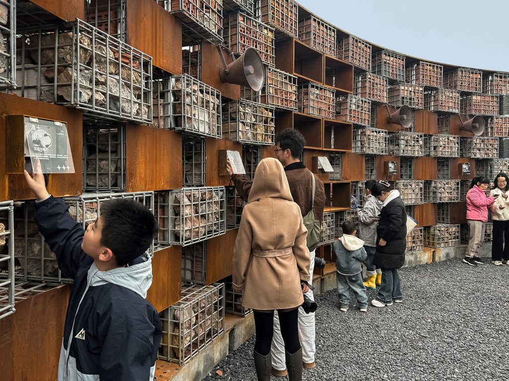 Visitors of different ages moving through the open-air museum