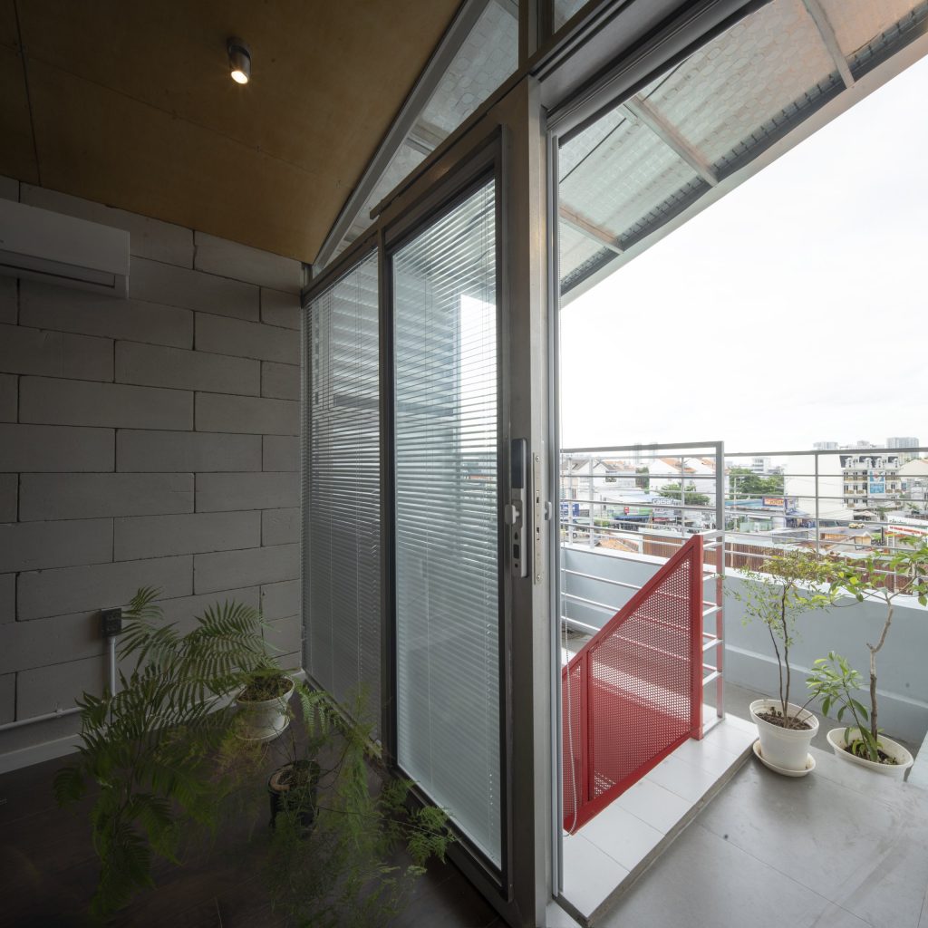 Room Above by scale50, Ho Chi Minh City, glazed corner opening to the balcony