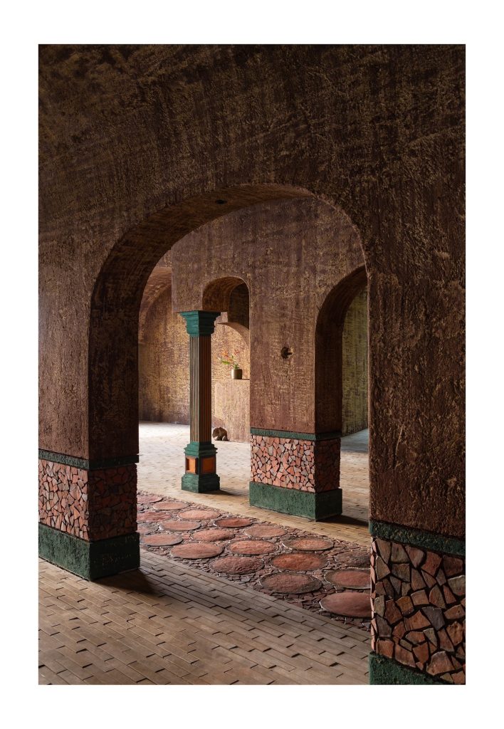Looking through a thick arch to the next bay