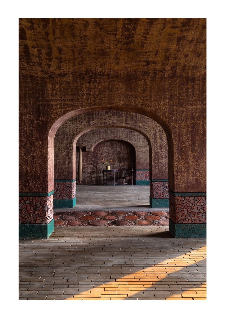 Sunlight on the floor through a row of arches