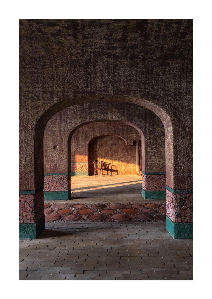 Arches framing a lit space beyond