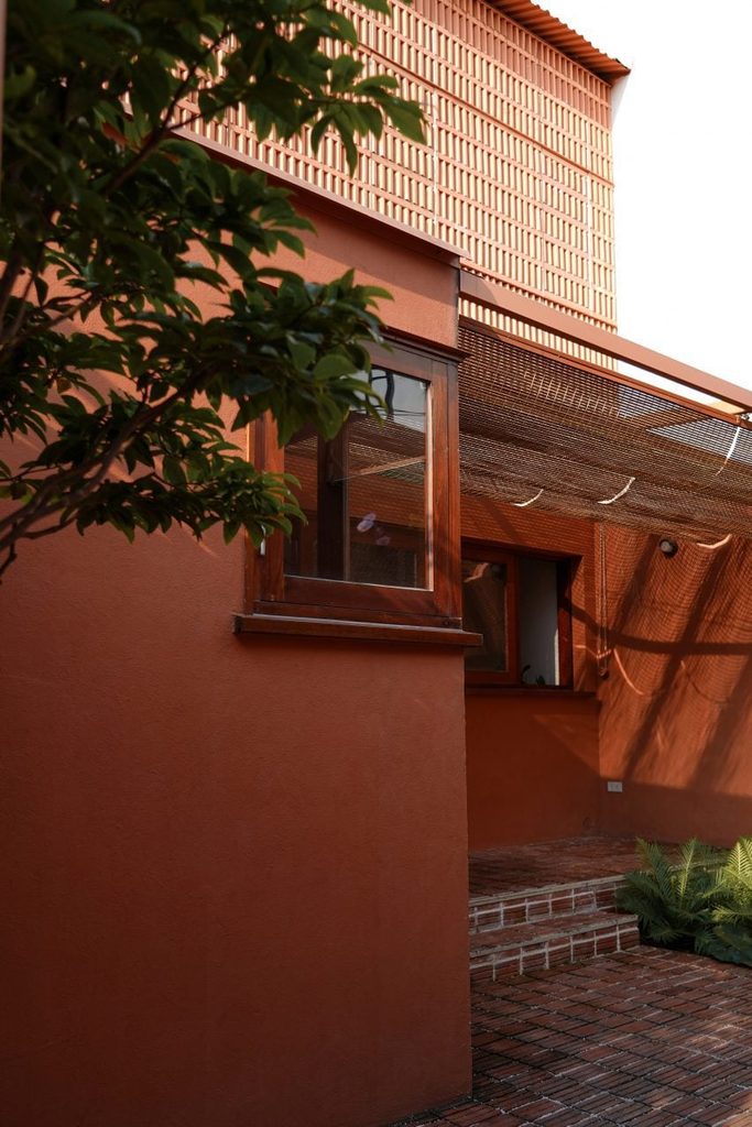 Brick screen above the shaded entrance courtyard