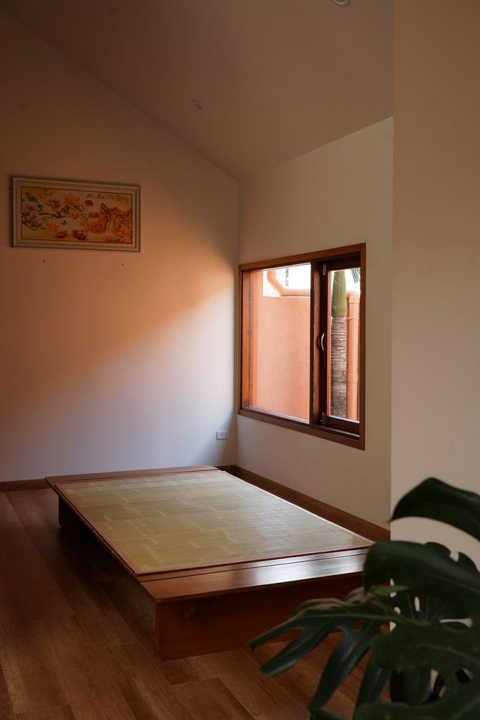 Bedroom with a timber bed and courtyard-facing window