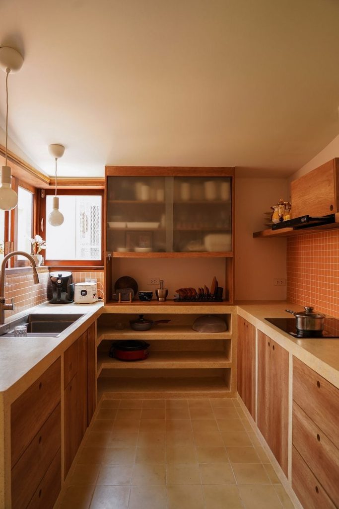 Kitchen with timber cabinets and terracotta-coloured wall tiles