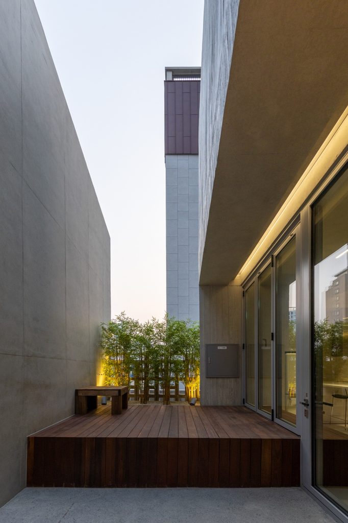 Timber terrace beside full-height glazing