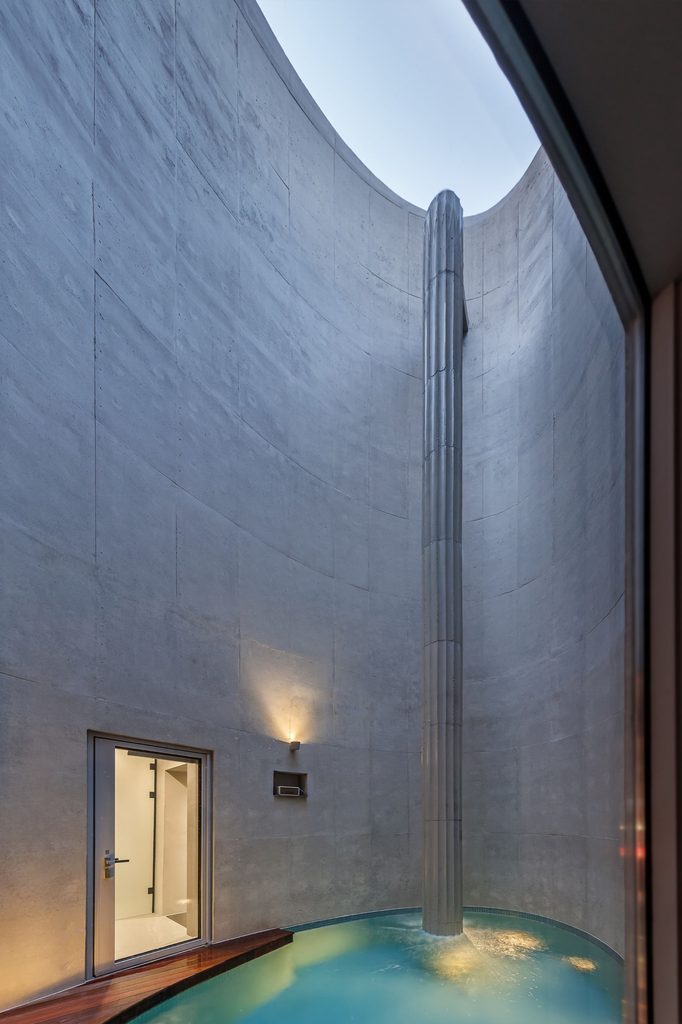 Oval pool enclosed by tall concrete walls