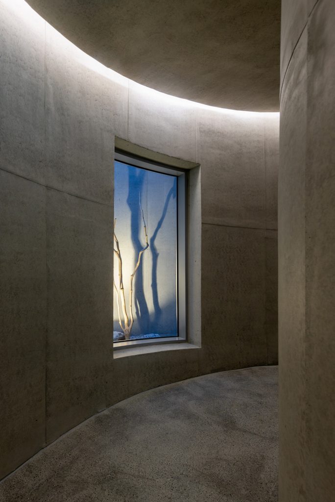 Curved corridor with concealed ceiling lighting