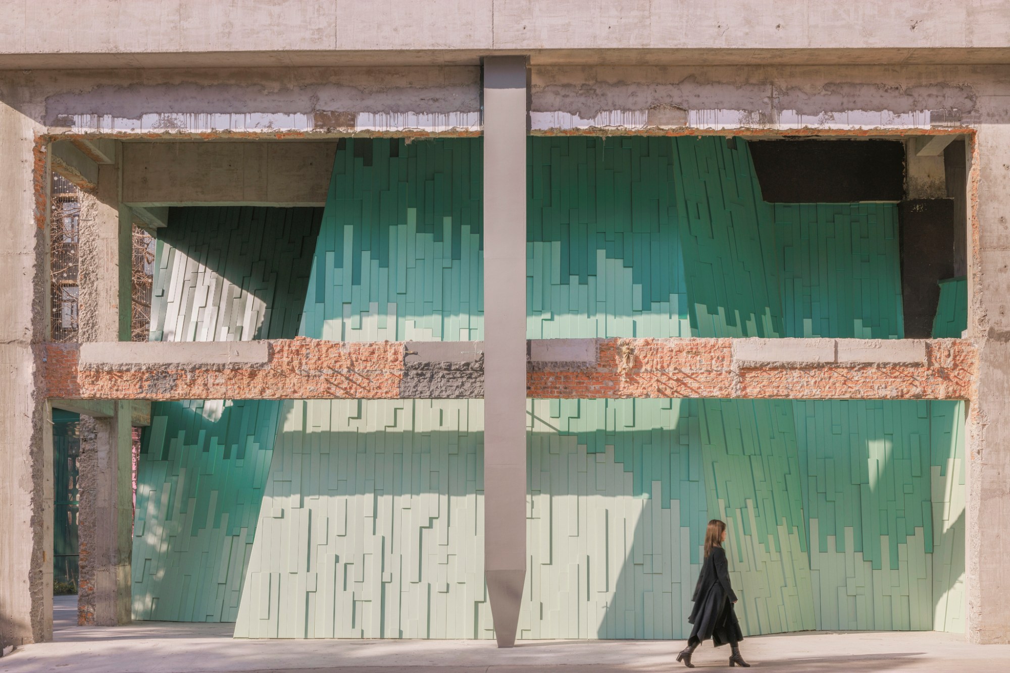 Green metal mountains behind the old concrete frame