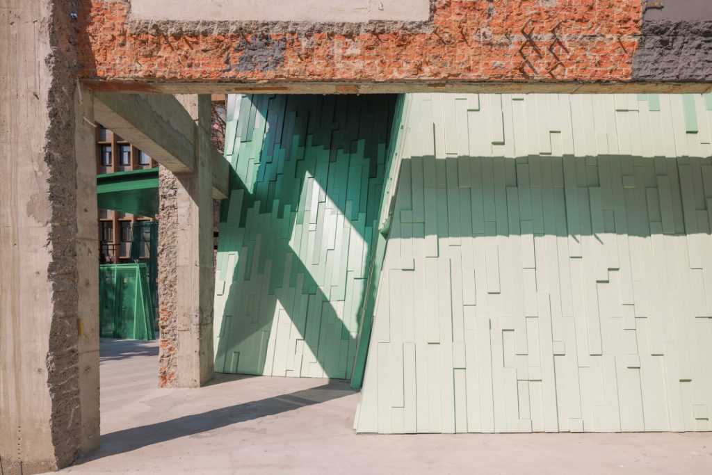 Green panels and weathered concrete beam