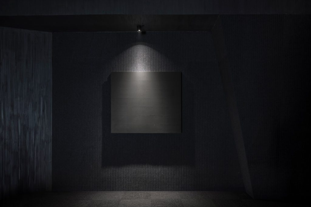 Lit niche at the end of the dark hall
