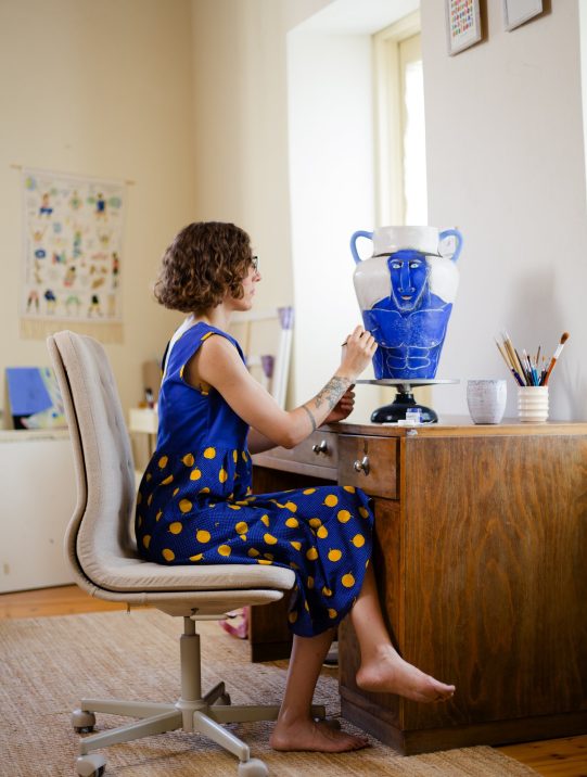 Trong thế giới nghệ thuật đương đại, nơi sự giao thoa giữa truyền thống và hiện đại liên tục được tái định nghĩa, Daphne Christoforou nổi bật với phong cách kể chuyện độc đáo bằng gốm và tranh minh họa. Xuất thân từ Cyprus, tốt nghiệp Royal College of Art (London), Daphne biến những chiếc bình gốm thành “cuốn sách tranh” sống động, nơi thần thoại Hy Lạp cổ đại gặp gỡ những suy tư cá nhân.