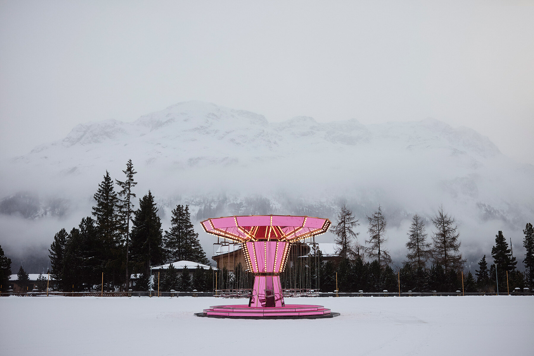 Carsten Höller’s pink mirror carousel slows time on the ice in St. Moritz