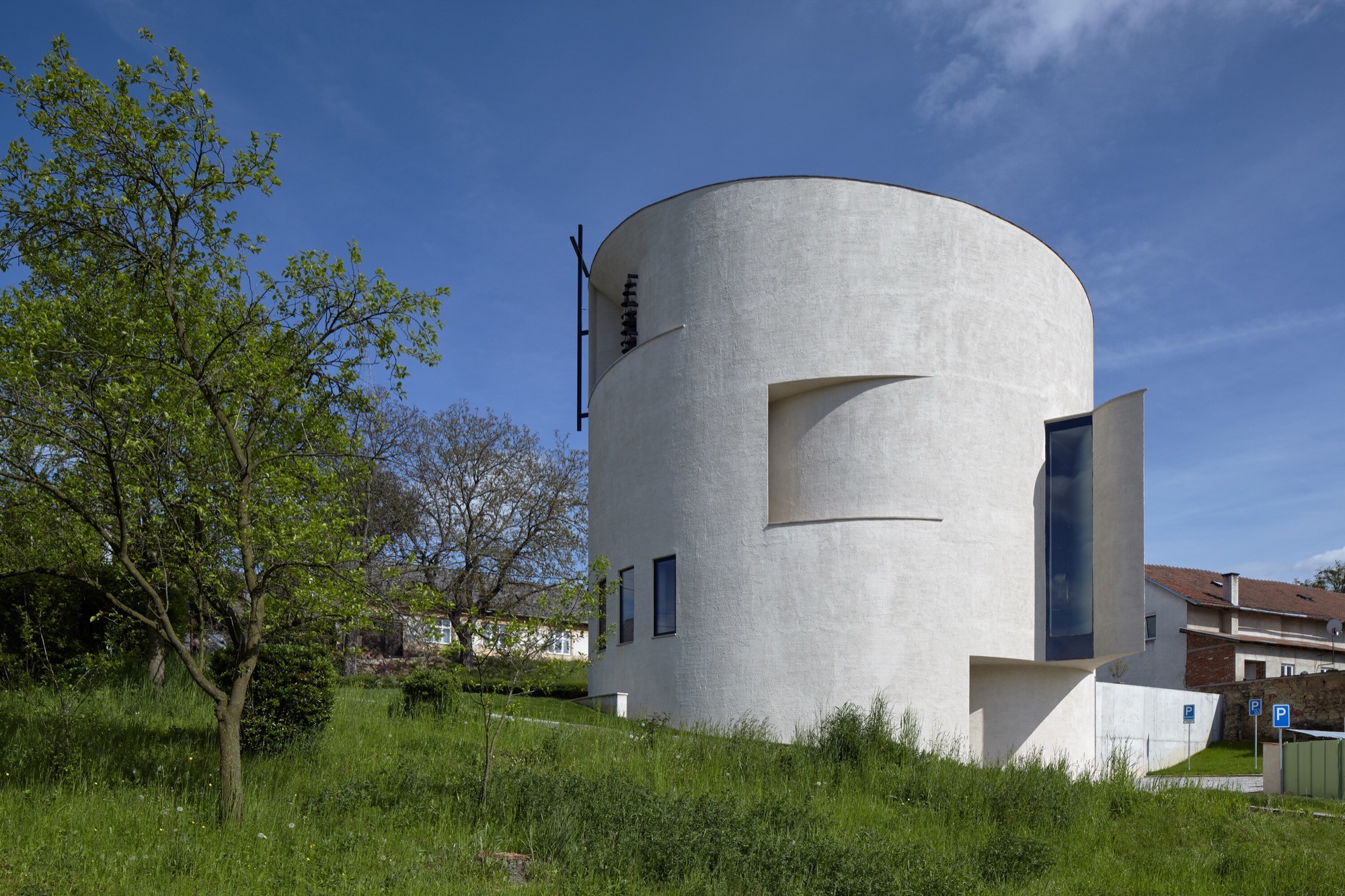 A cylindrical church in Sazovice filters light into a quiet sanctuary