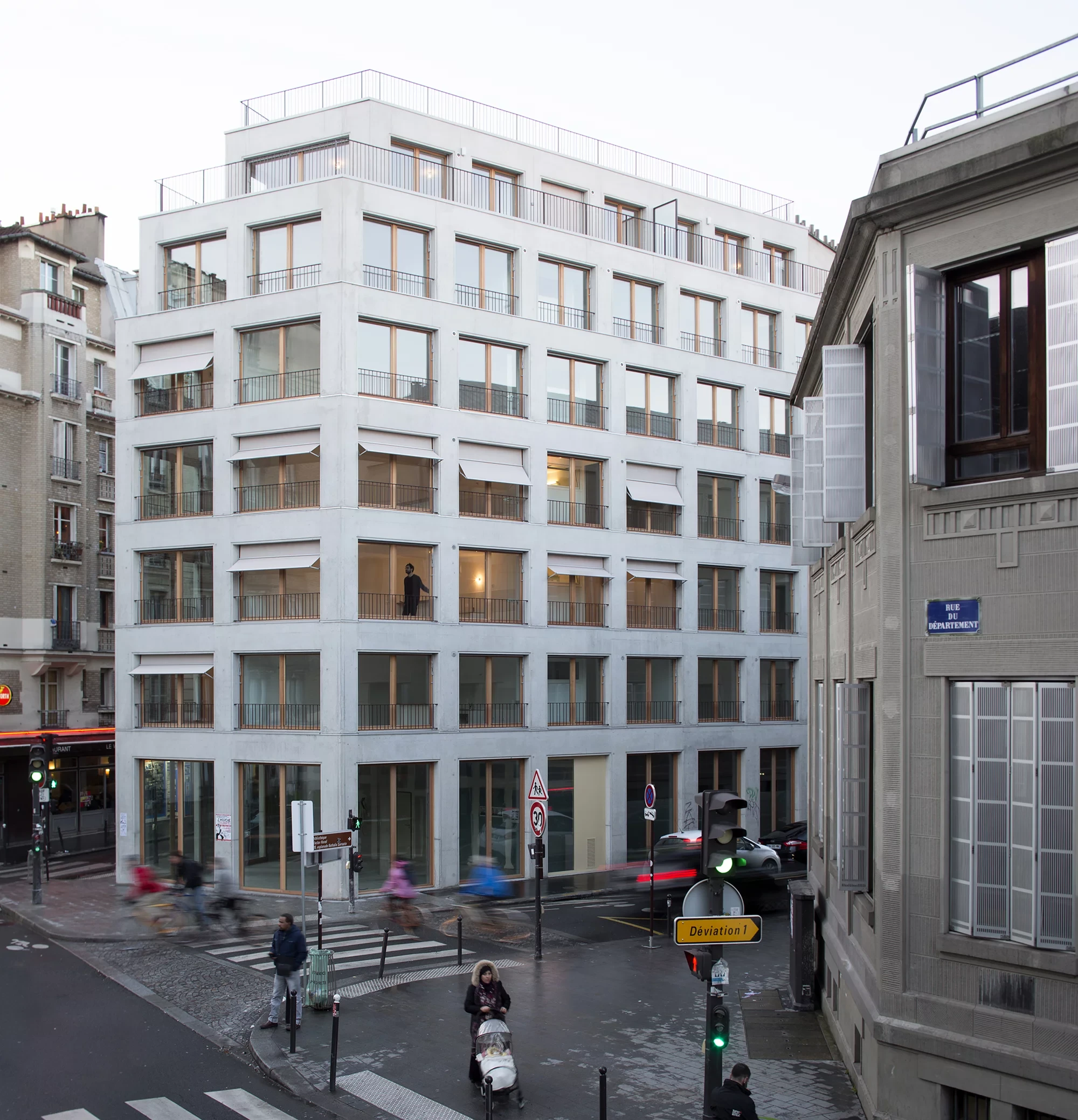 Paris social housing uses timber detailing and a double envelope to improve everyday comfort