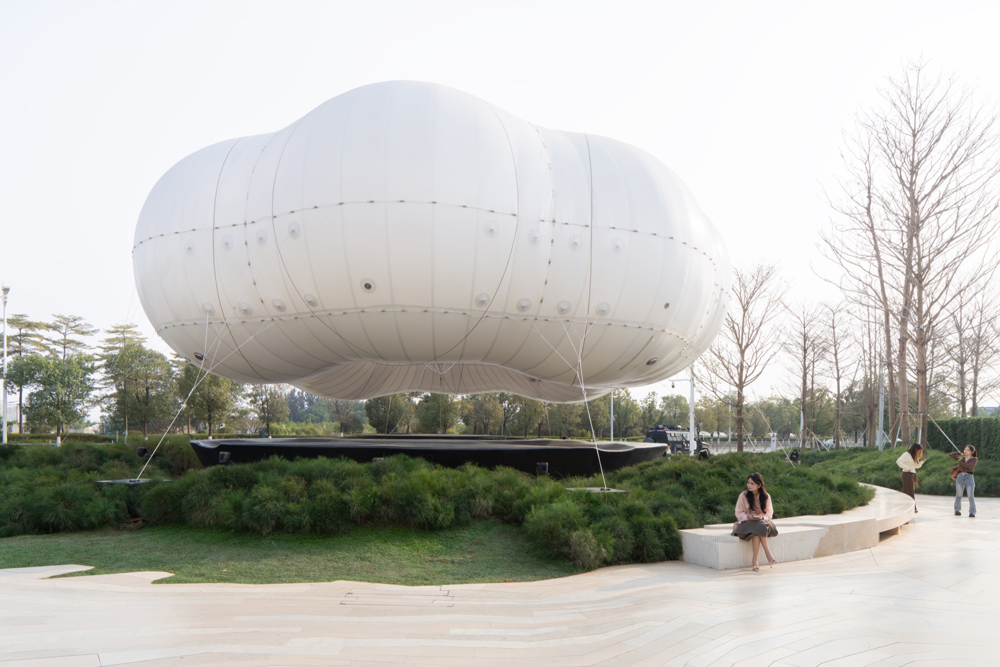 Inflatable cloud installation hovers above MIXC Village entrance in Dongguan