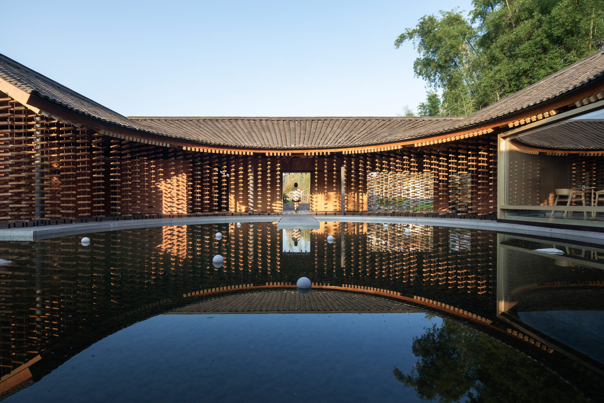 Suspended firewood walls enclose Shanshui Firewood Garden in Sichuan