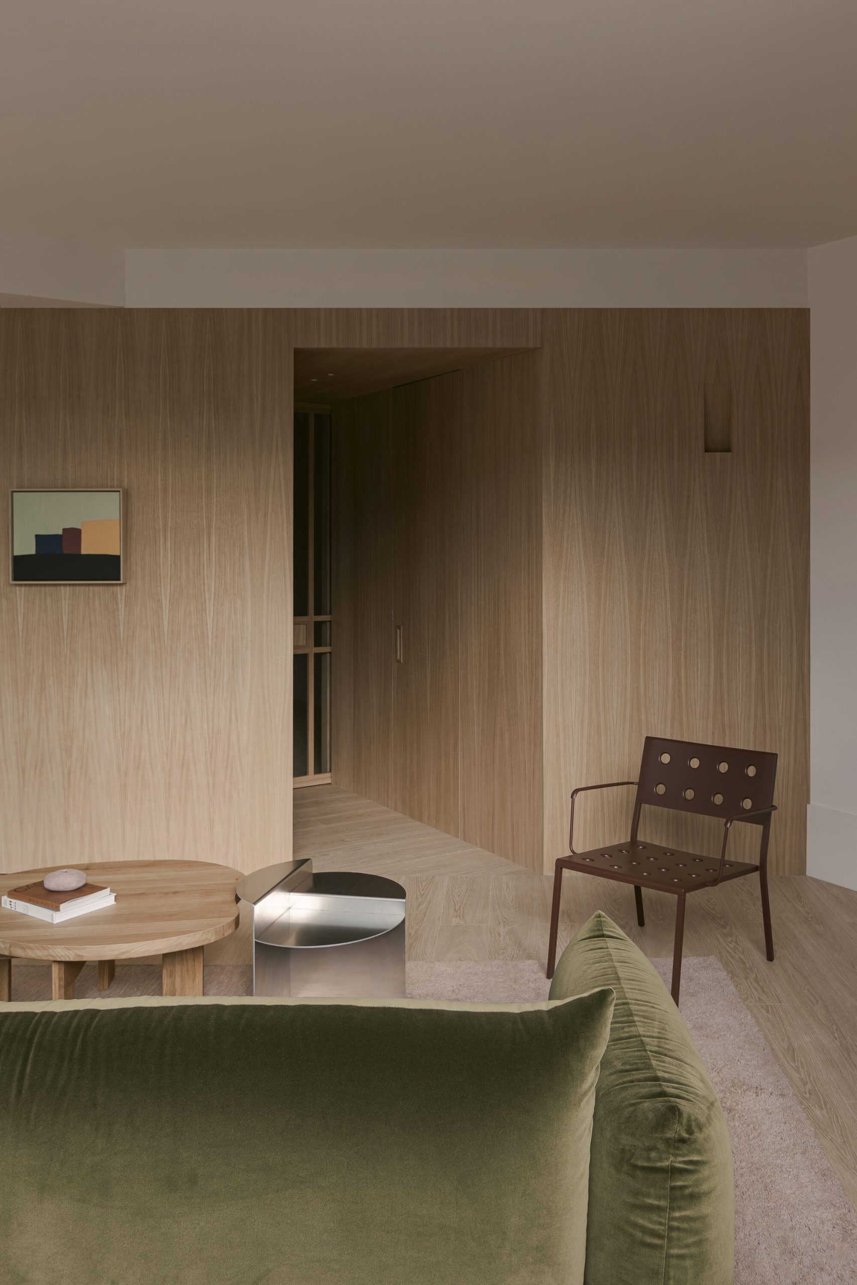 Oak joinery organises an irregular penthouse apartment in Madrid