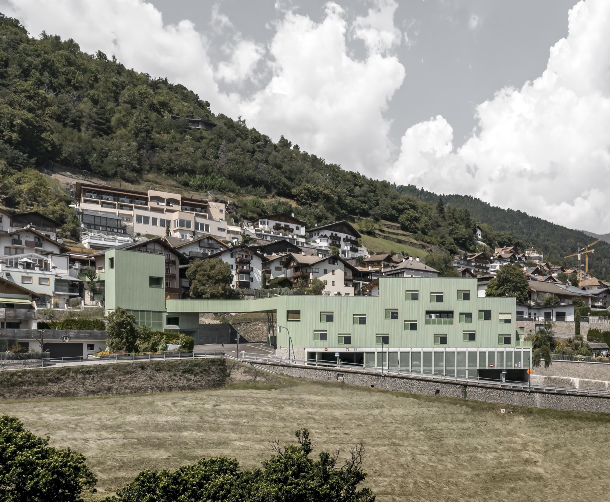 Roland Baldi Architects creates a green bridge for multifunctional building in Barbiano