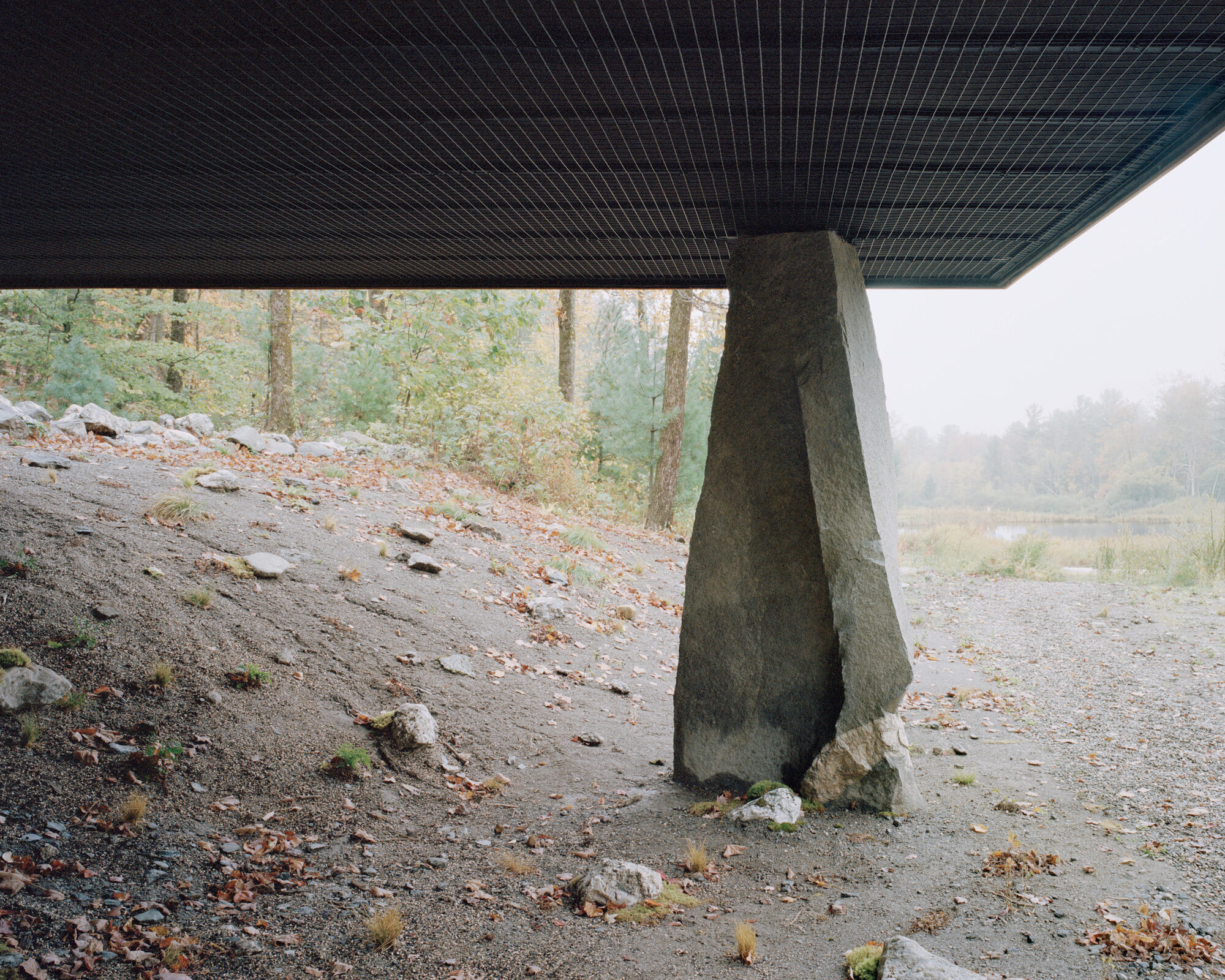 Of Possible raises larch cabin on ancient boulders in New York woodland