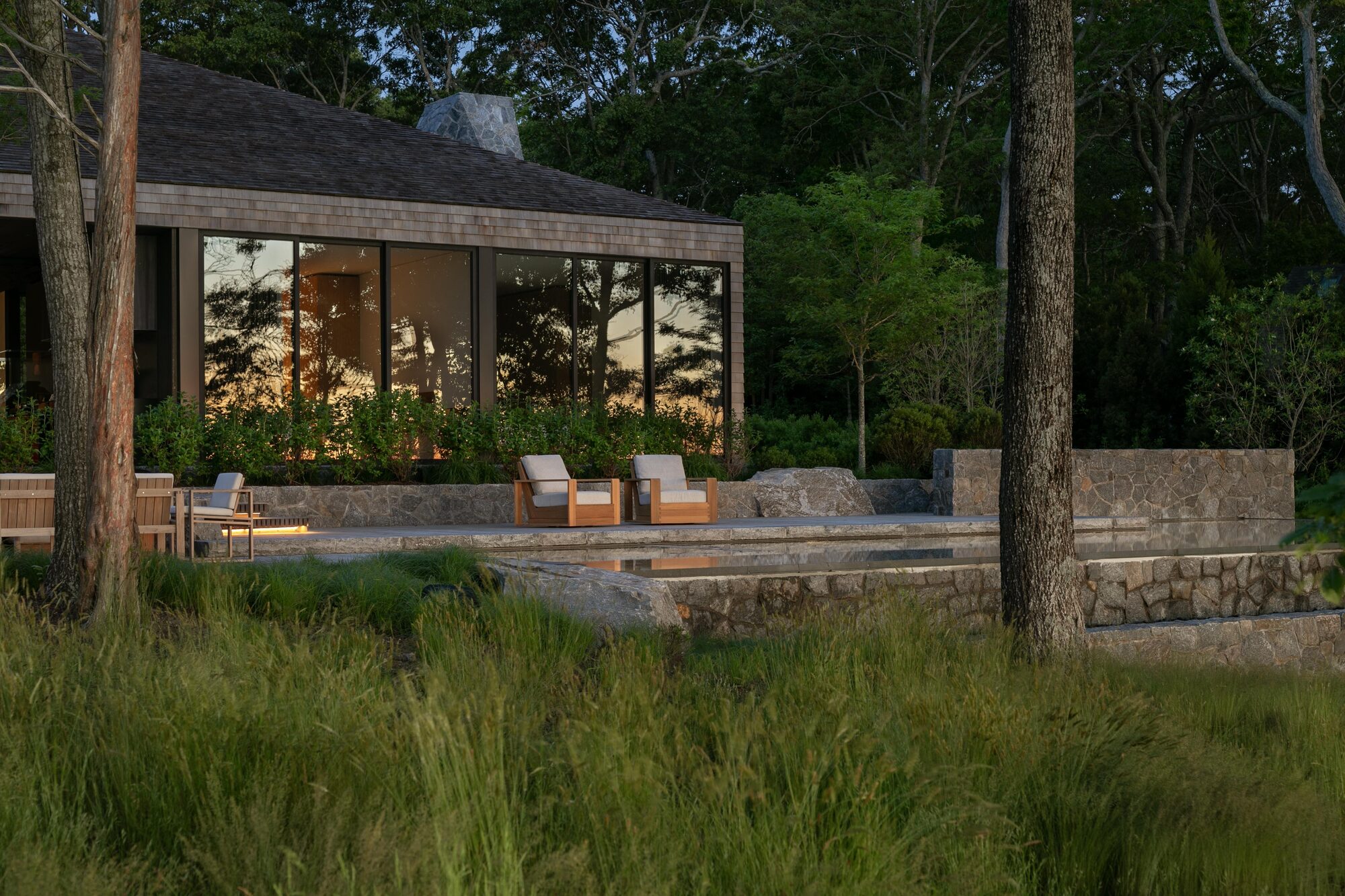 LaGuardia Design Group carves granite terraces into wooded Sag Harbor waterfront
