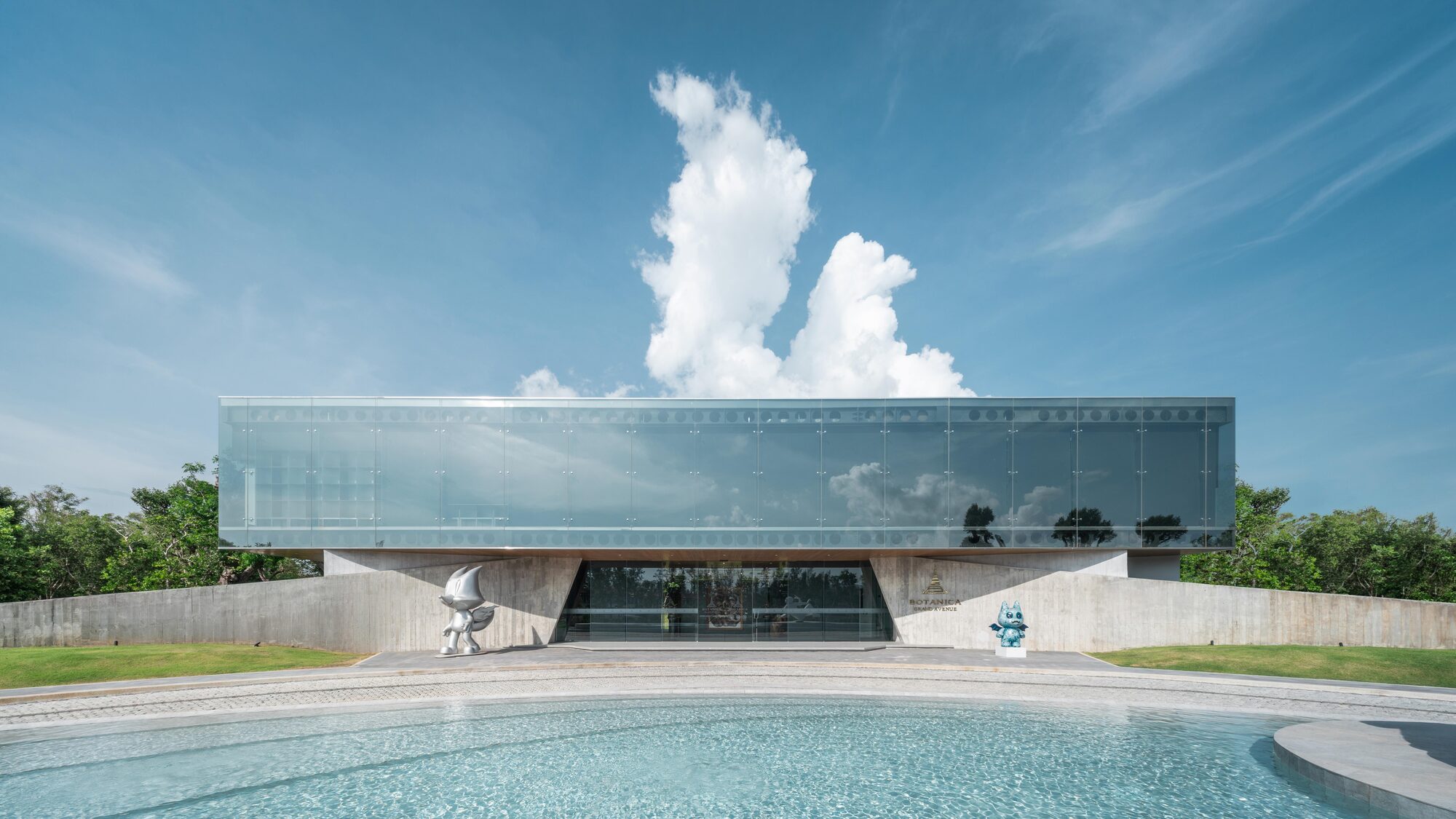 Reflective glass dissolves into sky at Rhyme Design Group's Phuket gallery