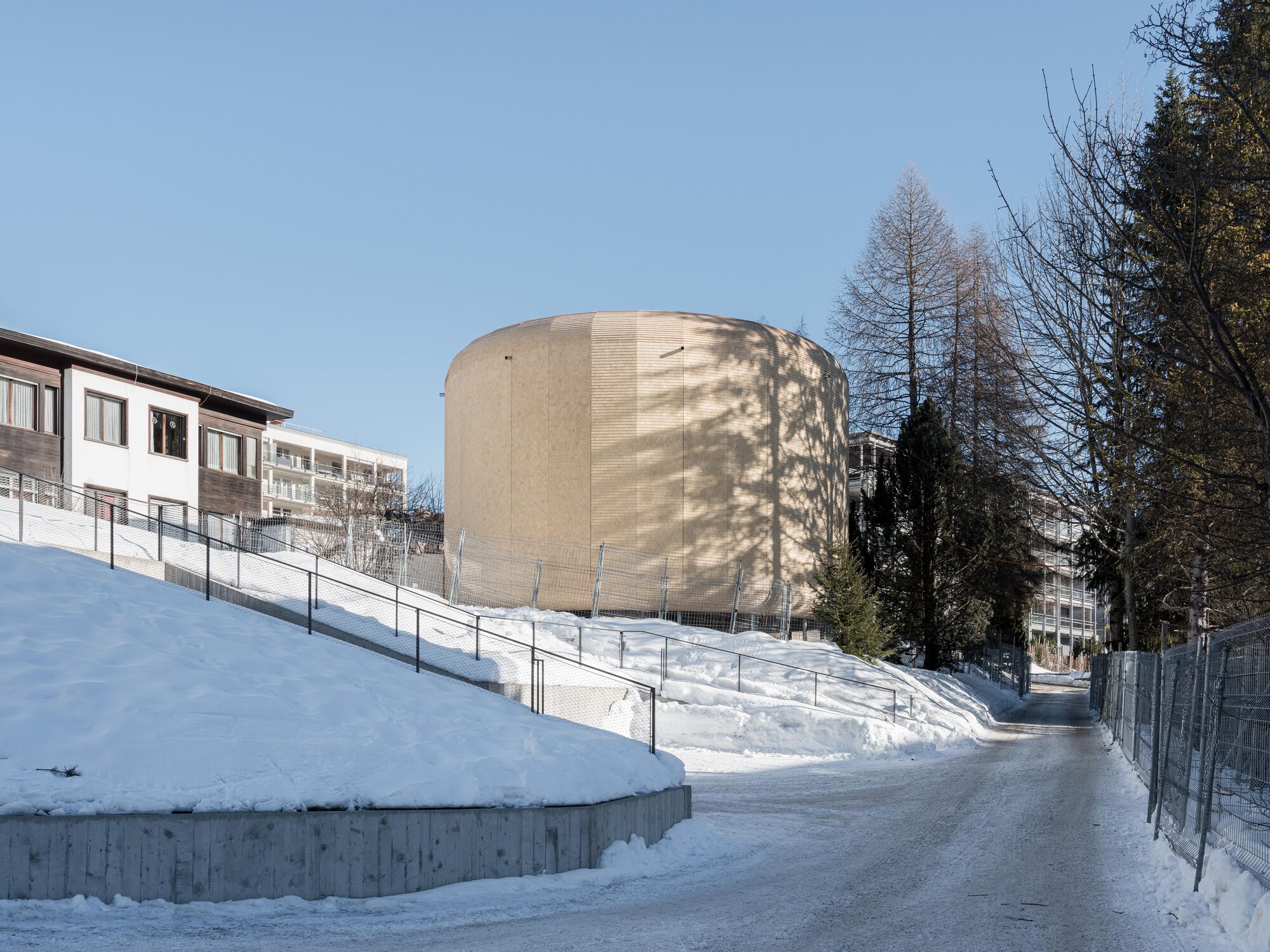 Timber shingles wrap modular pavilion by SkreinStudios in Davos