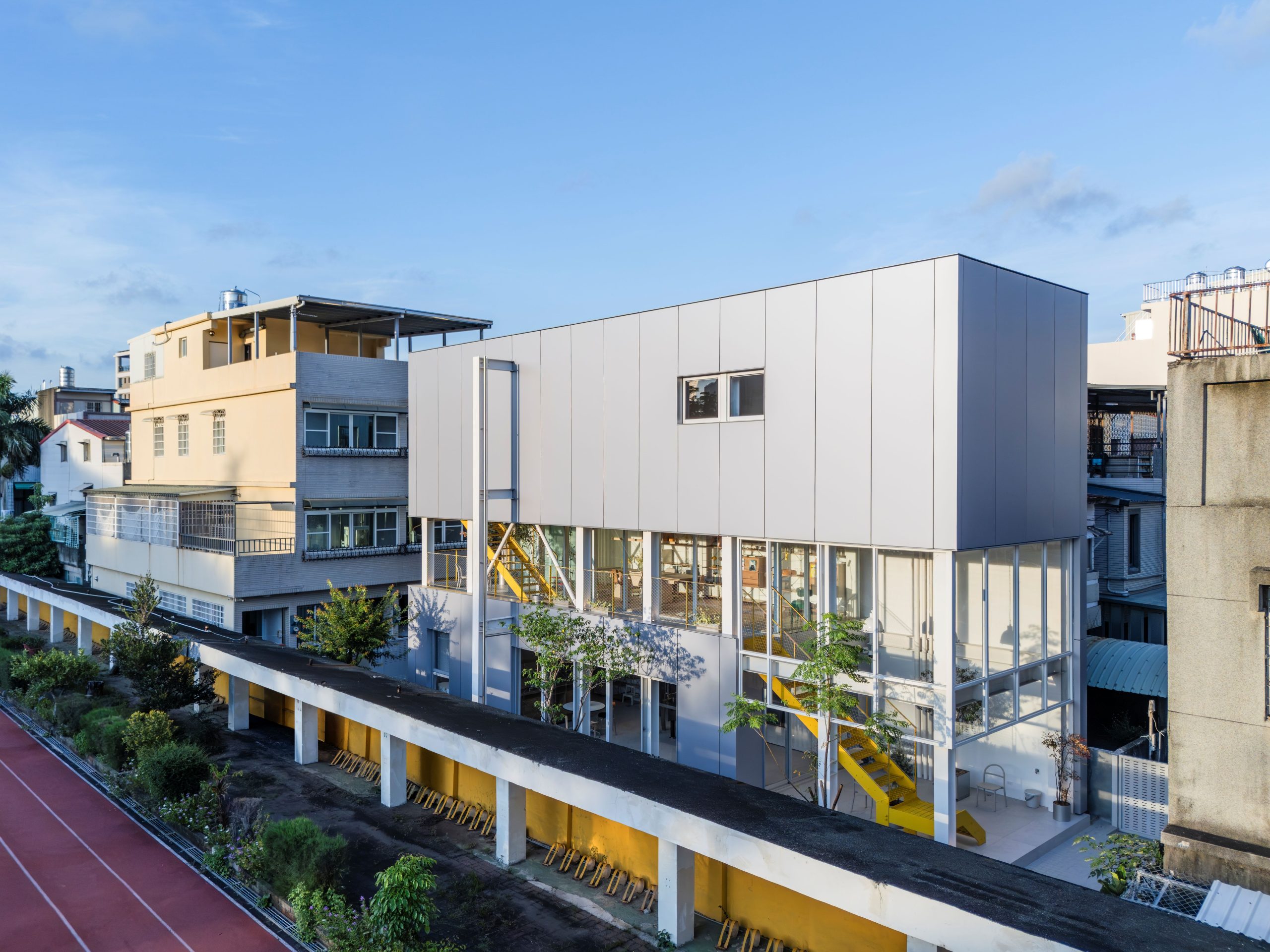 MOM House beside a school sports field in Kaohsiung