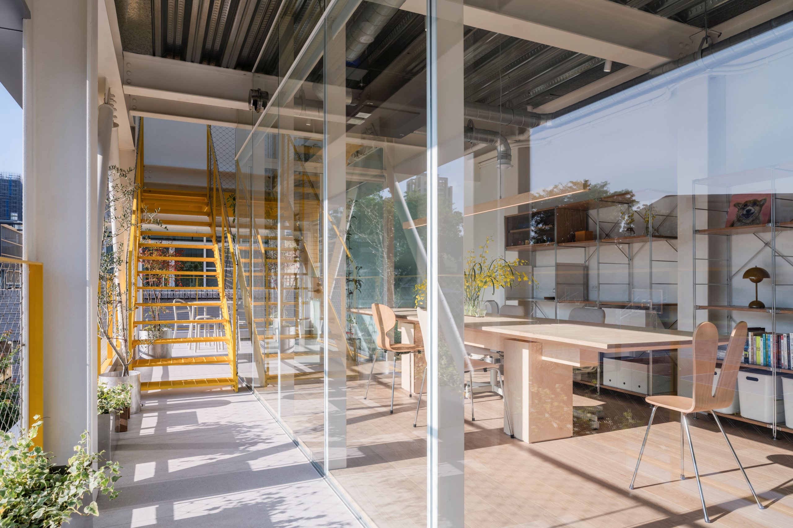 Interior of MOM House with exposed steel frame and yellow stair
