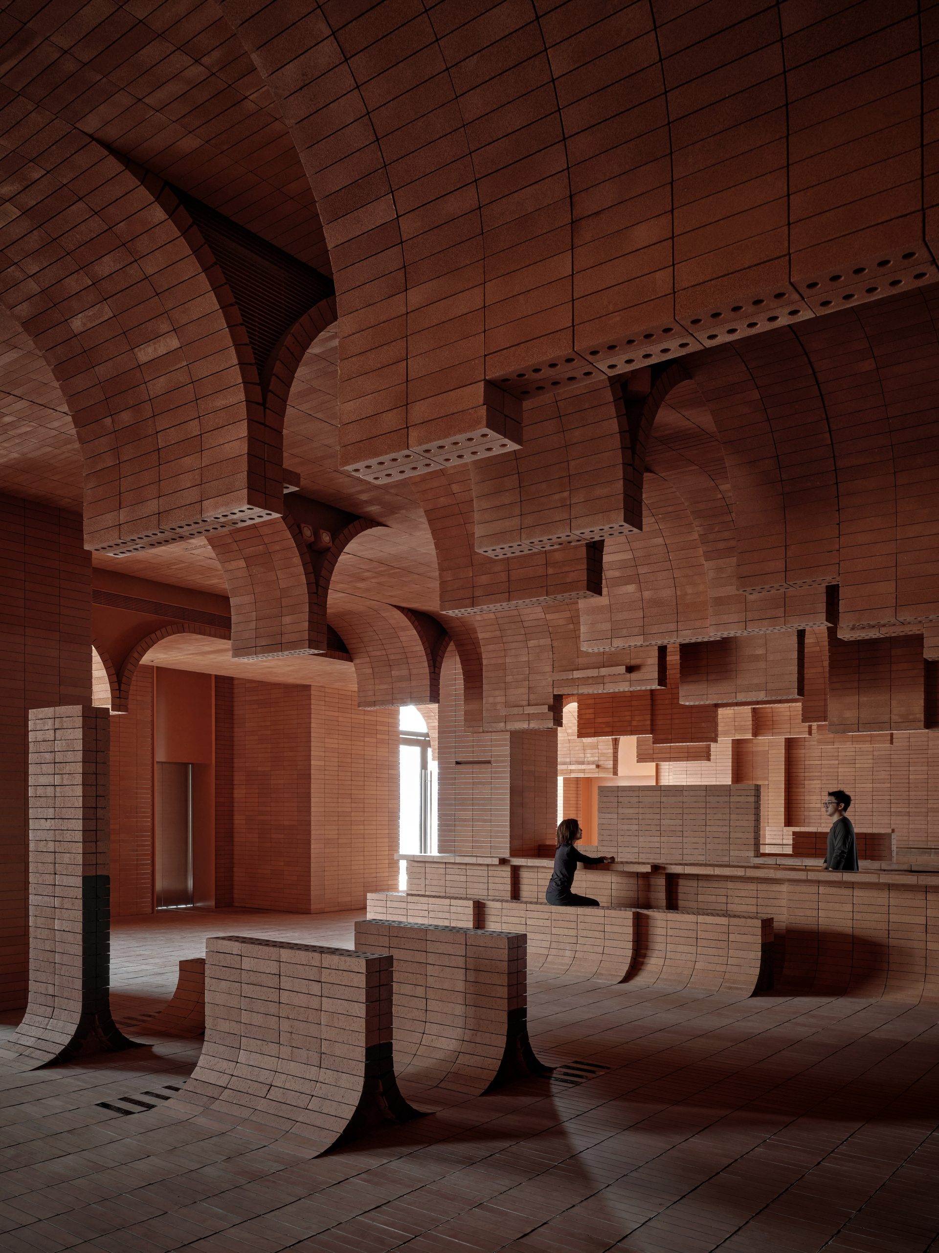 Wave-like brick walls at Haikou Gaoxingli Insun Cinema