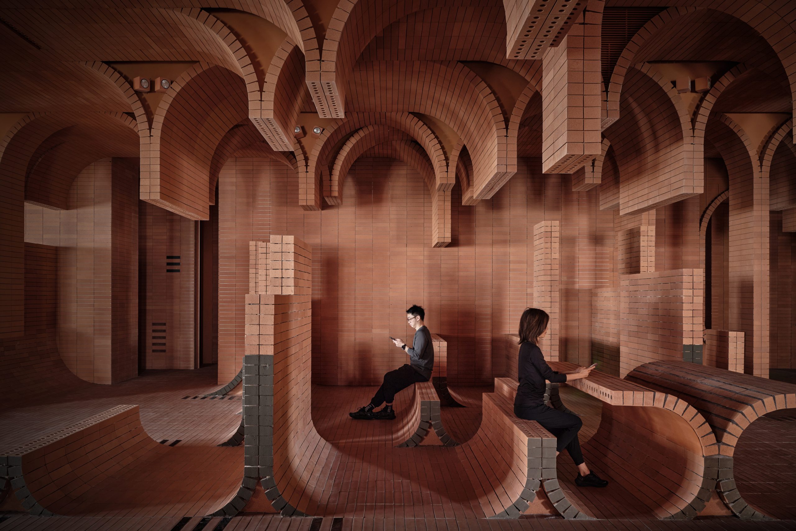 Brick and lighting details at Haikou Gaoxingli Insun Cinema