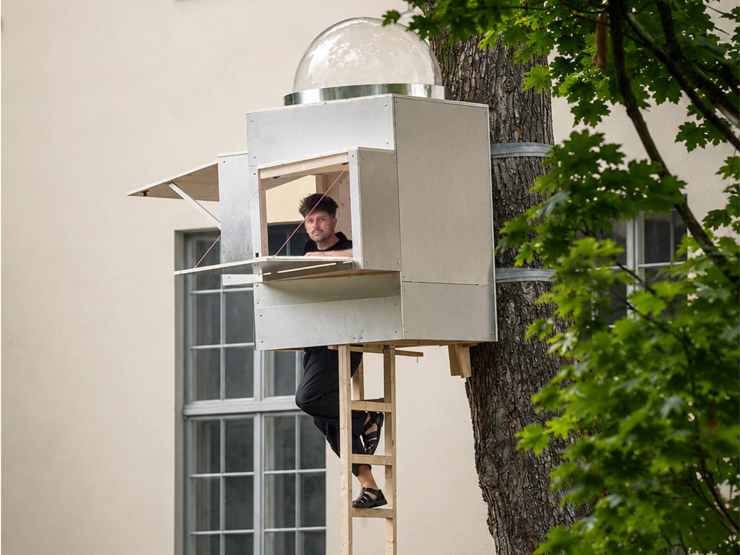 Skylight framing the tree canopy inside Opposite Office Baumhaus Office