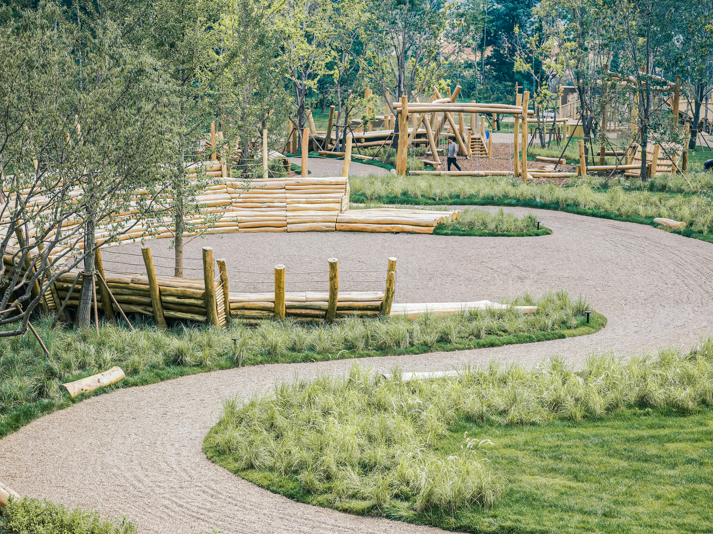 Semi-circular log amphitheater at Forest Delight by XISUI Design