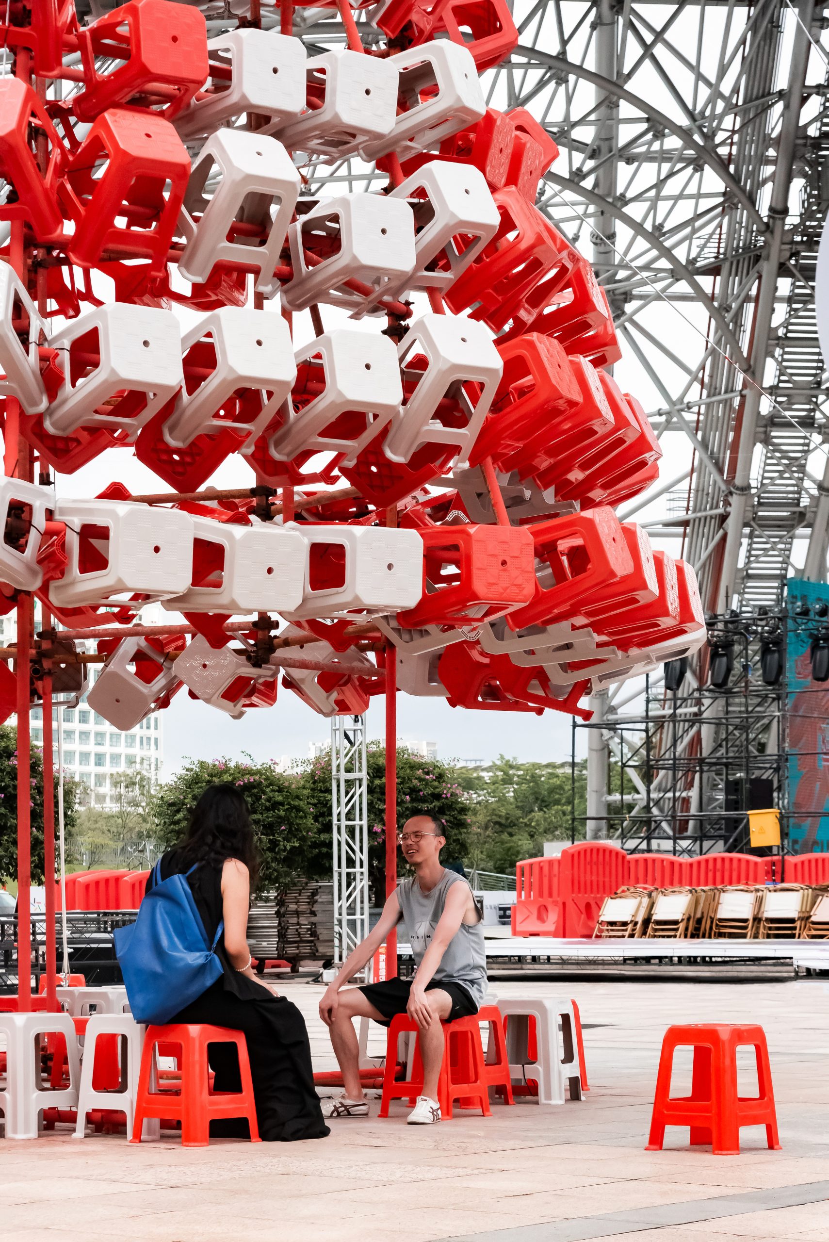 People resting beneath Stool Tower by 1Y Architects