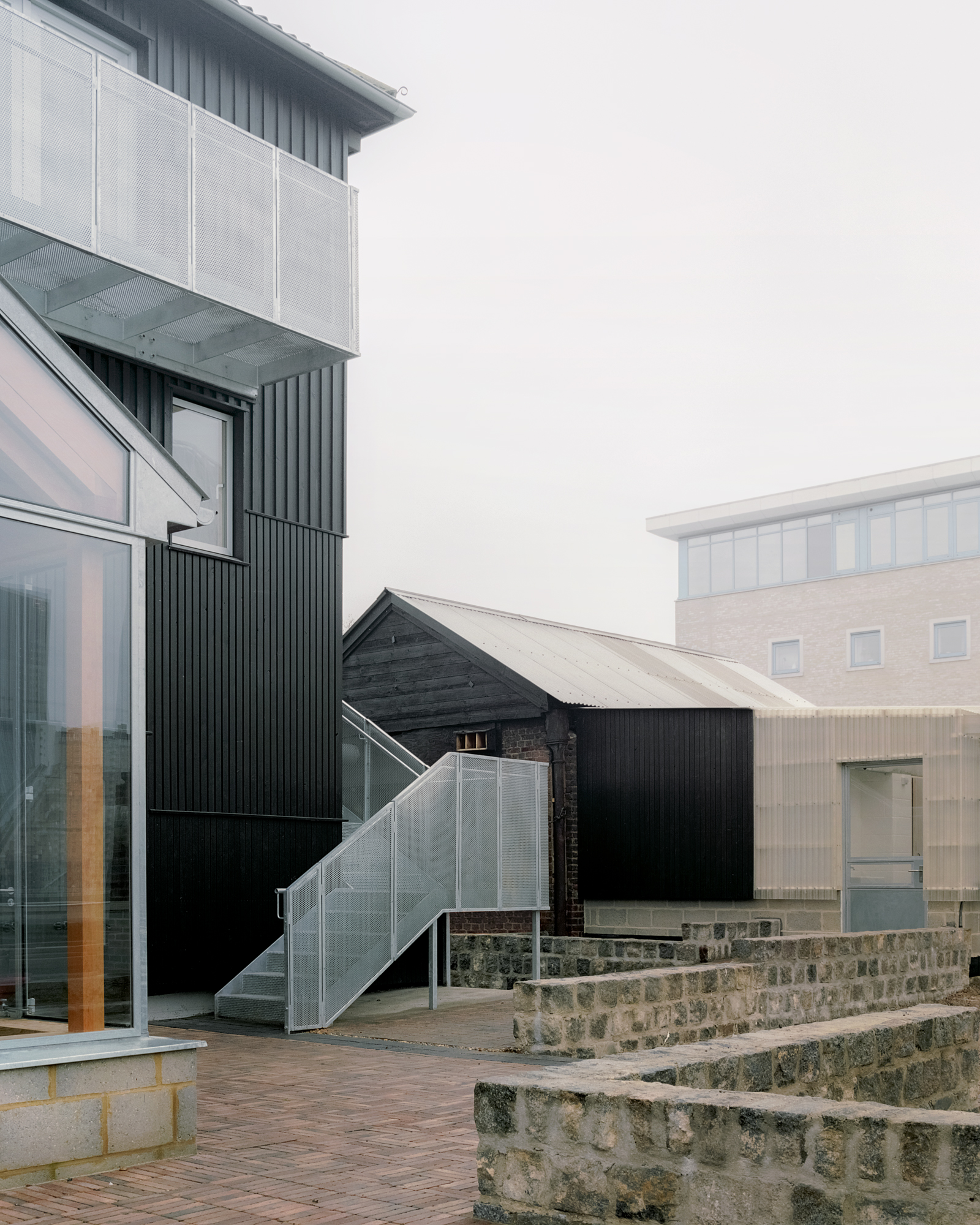 View toward the toilet block and forge at Surrey Docks Farm by Pup Architects. Photo by Simone Bossi.