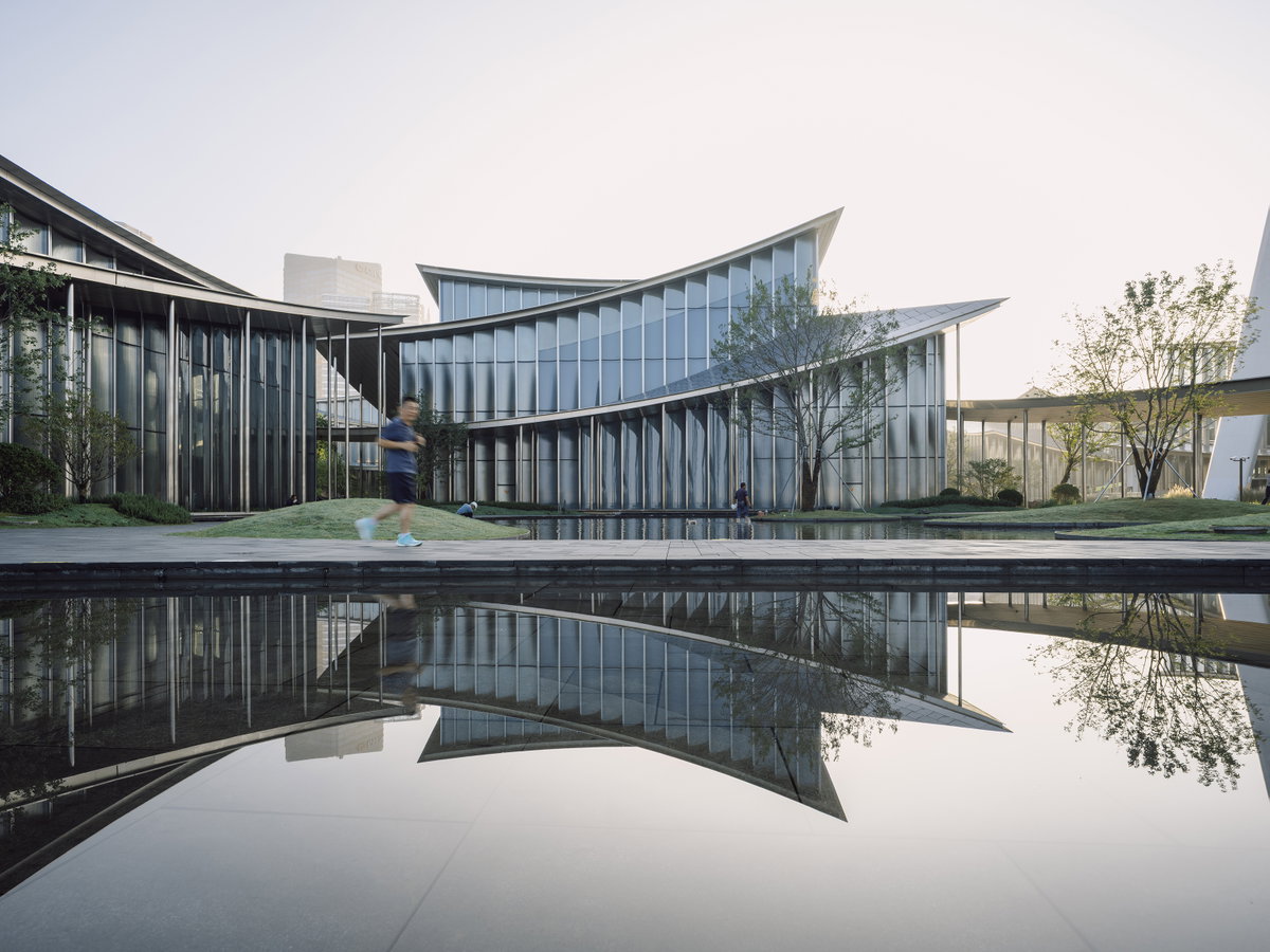 Curved covered corridor and reflective facade at Suzhou MoCA