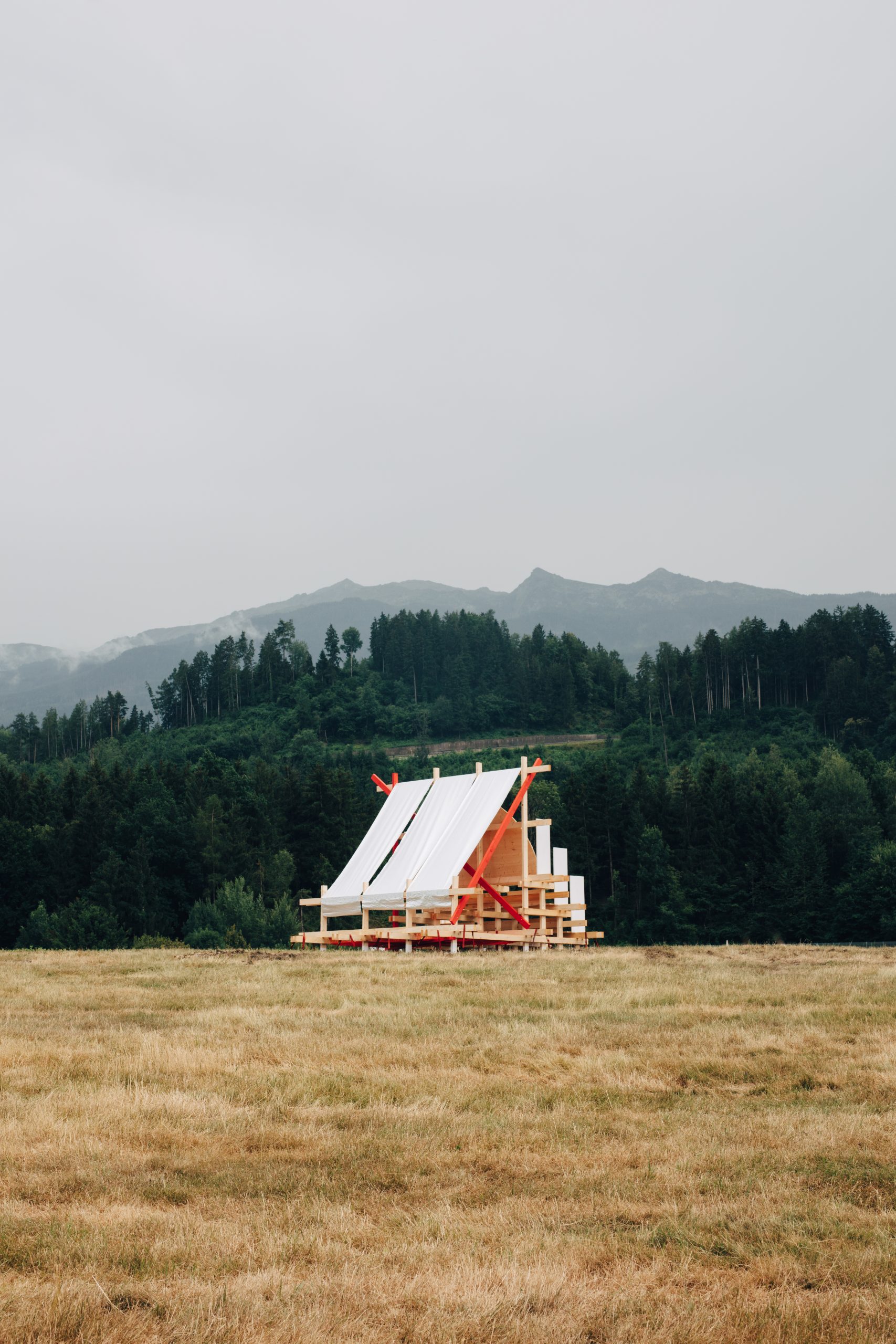 Reflective semicircular surface framing the mountain landscape
